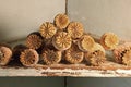 DRY POPPY SEED PODS STACKED ON AN OLD FLAKING SHELF Royalty Free Stock Photo