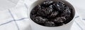Dry prunes in a bowl, side view. Close-up Royalty Free Stock Photo