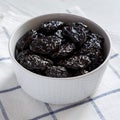 Dry prunes in a gray bowl, side view. Close-up Royalty Free Stock Photo