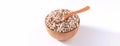 Dry raw brown tapioca pearls in a wooden bowl with spoon isolated on white background, close up, ingredient of making bubble boba