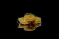 Dry, raw egg pasta capelli , isolated on black background. Cooking concept. Top view with copy space Royalty Free Stock Photo