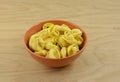 Dry raw tortellini pasta in bowl Royalty Free Stock Photo