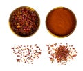 Dry red chili pepper slices and powder in round wooden bowl set isolated on white background. Royalty Free Stock Photo