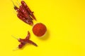 Dry Red chilli with chilli powder in glass bowl on yellow background Royalty Free Stock Photo