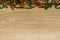 Dry red and green bell pepper on wood background. space for text