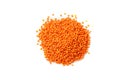Dry red lentils on a white background isolate. Red lentil grits. Red lentils pile isolated. Dry orange lentil grains