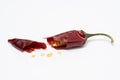 Dry red pepper pod with seeds on a white background. Broken dry pod in half Royalty Free Stock Photo