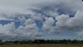 dry rice field conditions after planting rice seeds with a very beautiful view of the clouds Royalty Free Stock Photo