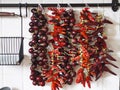 Dry ripe red hot peppers in a bunch as a decor in the kitchen. Chili pepper and round bitter. We grow ourselves Royalty Free Stock Photo