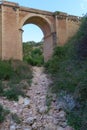 A dry river bed in the foreground, with a bridge passing overhead - the concept of Climate Change Royalty Free Stock Photo