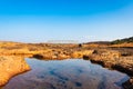 Dry river rock formation with water and vintage iron bridge and blue sky at morning Royalty Free Stock Photo