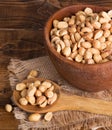 Dry Roasted Peanuts in a Wooden Bowl and Spoon Royalty Free Stock Photo