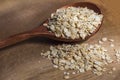 Dry rolled oat flakes oatmeal on old wooden table