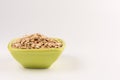 Dry rolled oatmeal in bowl isolated on white background Royalty Free Stock Photo