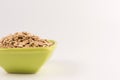 Dry rolled oatmeal in bowl isolated on white background Royalty Free Stock Photo