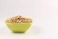 Dry rolled oatmeal in bowl isolated on white background. Royalty Free Stock Photo