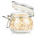 Dry rolled oats in a open transparent glass jar with rubber seal and metal clamp on lid isolated on white background Royalty Free Stock Photo
