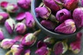 Dry rose buds flowers in a bowl close up.Asian ingredient for aromatherapy herbal tea. Royalty Free Stock Photo