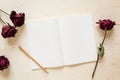 Dry rose and notebook paper with pencil Royalty Free Stock Photo