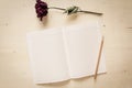 Dry rose and notebook paper with pencil Royalty Free Stock Photo