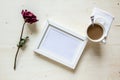 Dry rose and picture frame with coffee Royalty Free Stock Photo