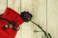 Dry roses with red small bag on wood pattern background Royalty Free Stock Photo