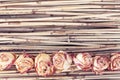 Dry roses on reed background