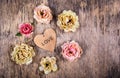 Dry roses and a wooden heart. Dead flowers and love. Romantic concept. Royalty Free Stock Photo