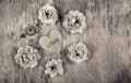 Dry roses and a wooden heart. Dead flowers and love. Romantic concept. Monochrome Royalty Free Stock Photo