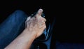 Dry skin hand with gear, old man driving car alone Royalty Free Stock Photo