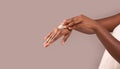 Dry Skin Treatment. Unrecognizable African American Woman Applying Moisturizing Cream On Hands Royalty Free Stock Photo