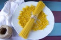 Dry spaghetti and fussily pasta at white plate Royalty Free Stock Photo