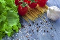 Dry spaghetti with sherry tomatoes and lettuce with spices, vertical photo