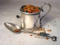 Dry spices in vintage silver cup and spoon on flax background Royalty Free Stock Photo