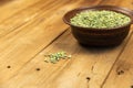 Dry split peas in a bowl against a wooden background. Green pea beans in brown earthenware bowl. Uncooked food. Healthy food. Royalty Free Stock Photo