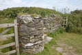 A dry stone wall and old gates close to the sea at Noss Mayo in Devon