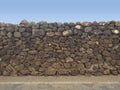 Dry stone wall to prevent landslides, floods and avalanches. Inca wall with blue sky background. Decorative brick fence wall