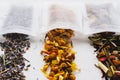 Dry tea in filter teabag sachet on white background. Green leaves, fruits, berries, lavender drink ingredient set