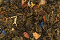Dry tea with fruit and flower petals as background. Dried tea background. Tea texture