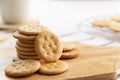 Dry thin circle crispy crackers on cutting board on wood table. Royalty Free Stock Photo