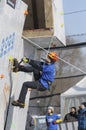 Dry tooling, training. Man in sportswear climbs on a wall using an ice axe