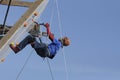 Dry tooling, training. Man in sportswear climbs on a wall using an ice axe