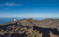 Dry tree roots at highest peak of La Palma Roque De Los Muchachos with big telescopes of Observatory at Caldera De