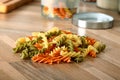 Dry tricolor rotini pasta on wooden kitchen desk