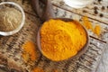 Dry turmeric root powder with ground black pepper in the background Royalty Free Stock Photo
