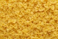 Dry uncooked farfalle pasta as a background Royalty Free Stock Photo