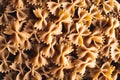 Dry uncooked farfalle pasta as a background. Flat lay. Royalty Free Stock Photo