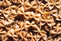 Dry uncooked farfalle pasta as a background. Flat lay. Royalty Free Stock Photo