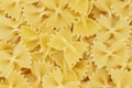 Dry uncooked farfalle pasta as a background. Flat lay Royalty Free Stock Photo