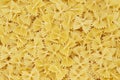Dry uncooked farfalle pasta as a background. Flat lay Royalty Free Stock Photo